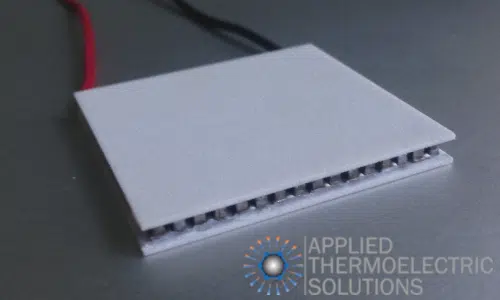 A thermoelectric / Peltier module showing a positive and negative wire, the thermoelements and ceramic plates
