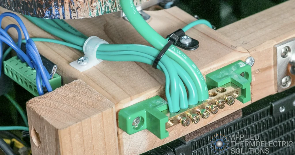 Thermoelectric cooling system prototype grounding block and electrical connection